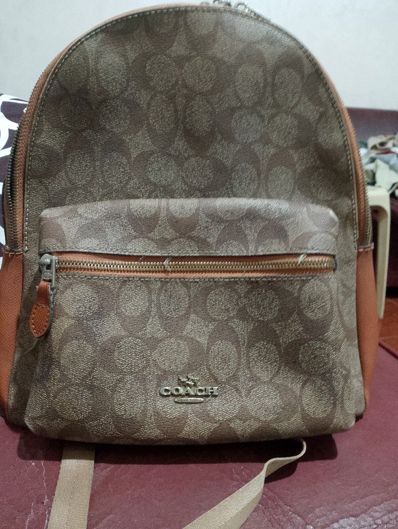 Authentic Coach Charley Backpack 35087H Signature Canvas - Preloved (Category: Luxury Bags & Wallets) located in Manila. Submitted by majimesan (Listing ID 1461712355, Image 1). Description: For sale: Authentic Coach Charley Backpack Details: - Style: 35087H - Material: Signature Coated Canvas + Crossgrain Leather - Color: Brown / Tan (Khaki Saddle) - Size: Medium (fits laptop 13", A4) - Hardware: Silver, with COACH engraved zippers Condition: Us