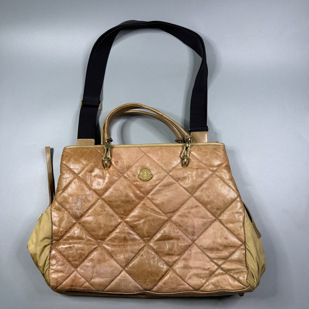 (Authentic) Moncler - 2-Way Quilted Leather Handbag Gold Hardware (Category: Luxury Bags & Wallets) located in Paranaque City. Submitted by millennial_goodz (Listing ID 1461769398, Image 1). Description: WTS (Authentic) Moncler - 2-Way Quilted Leather Handbag Gold Hardware Large size Authentic Flaw: Signs of usage (see photos) Raccagni Zippers With hologram P10,000 DM.