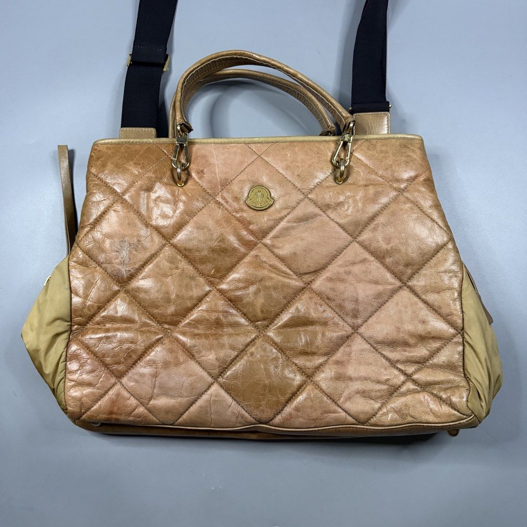 (Authentic) Moncler - 2-Way Quilted Leather Handbag Gold Hardware (Category: Luxury Bags & Wallets) located in Paranaque City. Submitted by millennial_goodz (Listing ID 1461769398, Image 3). Description: WTS (Authentic) Moncler - 2-Way Quilted Leather Handbag Gold Hardware Large size Authentic Flaw: Signs of usage (see photos) Raccagni Zippers With hologram P10,000 DM.