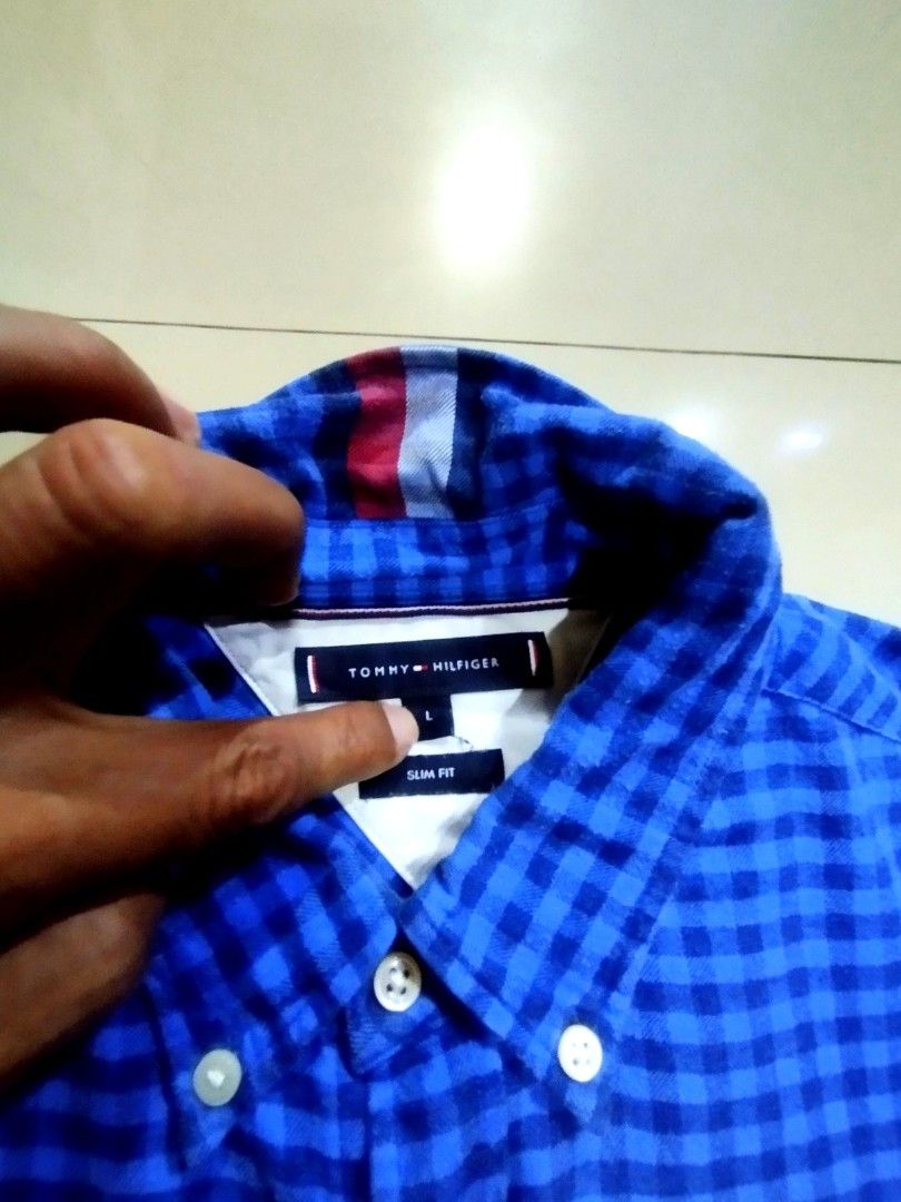 Authentic Tommy Hilfiger Blue Gingham Slim Fit Button Down Shirt Size L (Category: Formal Shirts) located in Manila. Submitted by onimusha032014 (Listing ID 1461690857, Image 2). Description: - Tommy Hilfiger Blue Gingham Shirt - Size: L - Fit: Slim Fit - Style: Button-Down - Pattern: Classic Checkered - Condition: Good, no obvious flaws - Perfect for casual or smart-casual occasions.