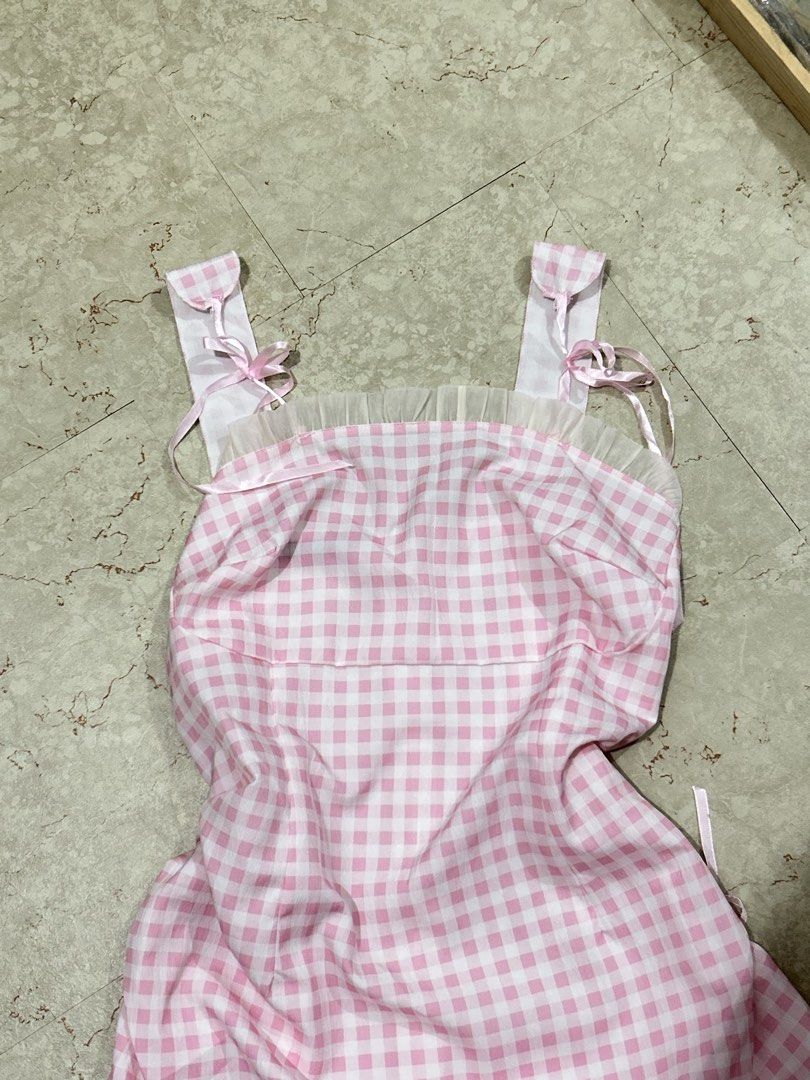 Baby Pink Gingham Ruffle Strap Dress (Category: Dresses) located in Batangas. Submitted by nommi26 (Listing ID 1461682342, Image 2). Description: - Adorable pink gingham pattern - Features charming ruffle straps with ribbon ties - Cute tie details on the sides for adjustable fit - Ideal for summer outings, picnics, or a sweet, feminine look - Easy to wear and style.