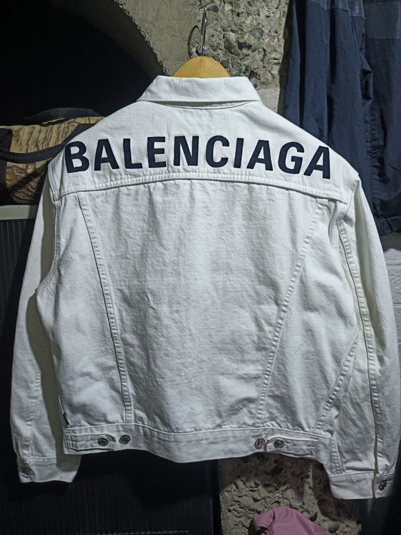 Balenciaga Denim Jacket (Category: Coats, Jackets and Outerwear) located in Caloocan City. Submitted by gemfinder669 (Listing ID 1461724444, Image 2). Description: - Brand: Balenciaga - Type: Denim Jacket - Color: White - Size: L (EU 52 / UK 42 / US 42) - Design: Classic denim jacket style with iconic Balenciaga logo embroidered on the back - Material: Denim - Style: Luxury streetwear Measurements: 23' width 24.5' length Color rate: 9.5/10 Condit
