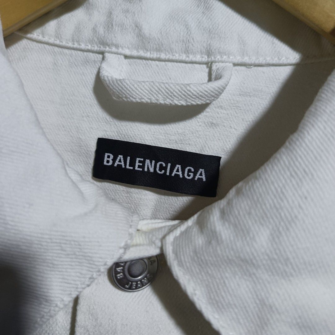 Balenciaga Denim Jacket (Category: Coats, Jackets and Outerwear) located in Caloocan City. Submitted by gemfinder669 (Listing ID 1461724444, Image 3). Description: - Brand: Balenciaga - Type: Denim Jacket - Color: White - Size: L (EU 52 / UK 42 / US 42) - Design: Classic denim jacket style with iconic Balenciaga logo embroidered on the back - Material: Denim - Style: Luxury streetwear Measurements: 23' width 24.5' length Color rate: 9.5/10 Condit