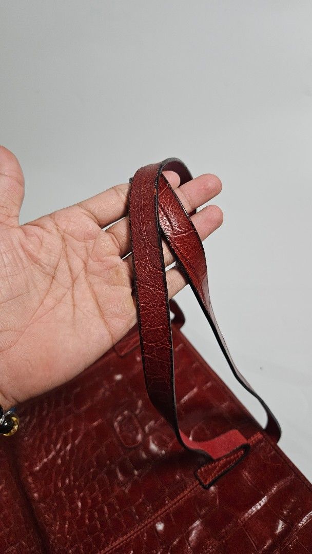 Bally Red Croc Embossed Leather Tote Bag (Category: Tote Bags) located in Alfonso. Submitted by jbcamet (Listing ID 1461710582, Image 3). Description: - Genuine red leather tote bag - Elegant croc embossing - Iconic Bally logo on the front - Spacious interior for all your essentials - Internal zippered pocket with Bally zipper pull - Durable leather straps - Unique and stylish shape - Ideal for everyday wear.