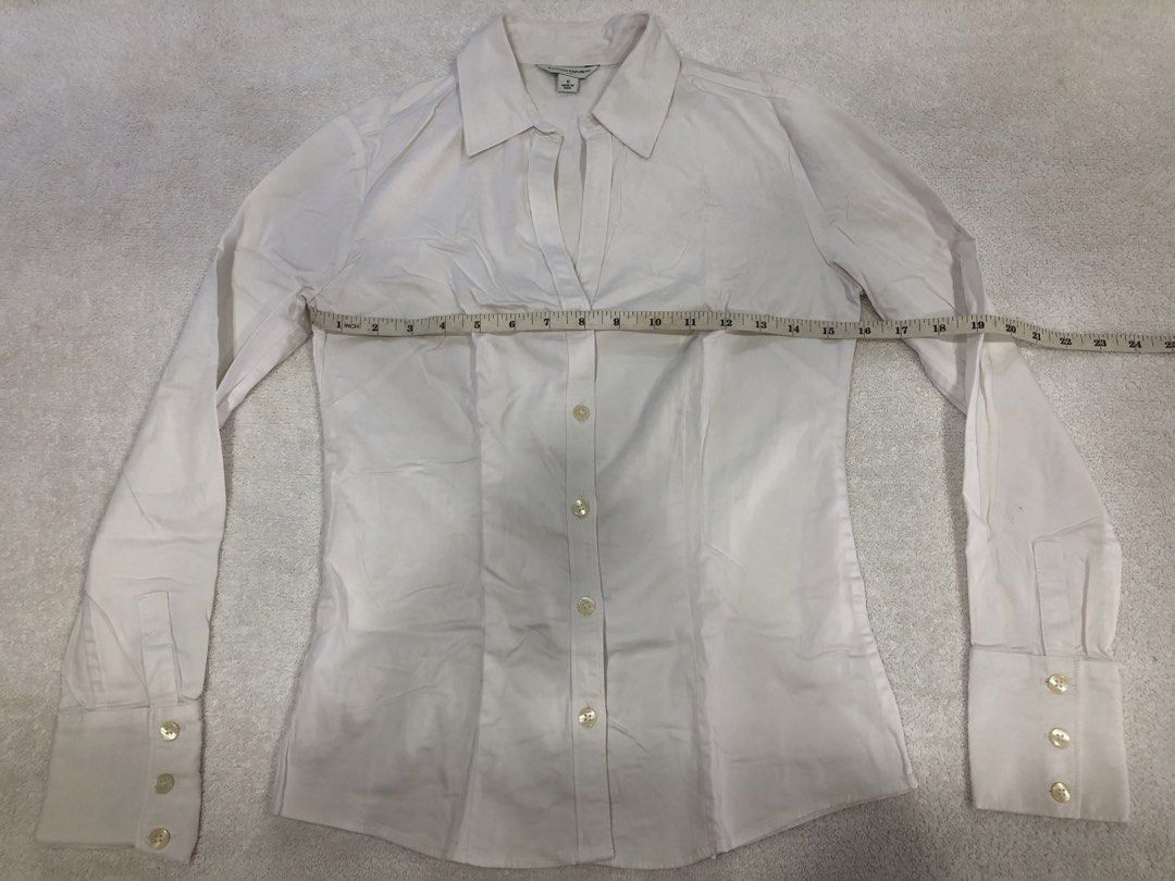 Banana Republic White Button-Up Shirt Size 0 (Category: Longsleeves) located in Manila. Submitted by janmichael26601 (Listing ID 1461617971, Image 1). Description: - Classic white button-up shirt from Banana Republic - Long sleeves with button cuffs - V-neckline with button closure - Tailored fit - Made in India - Measurements: Pit to pit approx 15 inches, length approx 23 inches.