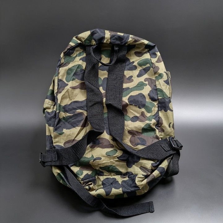 Bape Camouflage Backpack (Category: Backpacks) located in Baguio. Submitted by miishaysh67446 (Listing ID 1461665540, Image 2). Description: - Stylish camo print backpack - Convenient front zipper pocket - Adjustable straps for a comfortable fit - Minor wear on zipper and strap stitching - Small stain on inner tag - Still in good, functional condition.