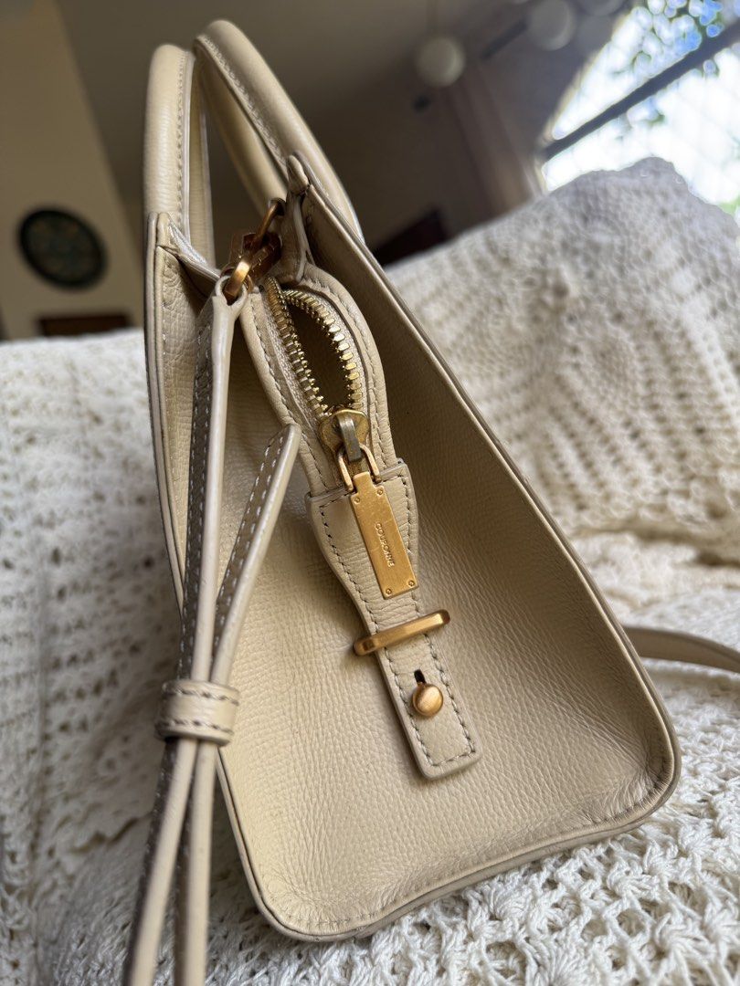Beige Leather Top Handle Bag (Category: Luxury Bags & Wallets) located in Bacolod City. Submitted by vintage_vogue6100 (Listing ID 1461669529, Image 3). Description: - Color: Beige - Material: Leather - Design: Structured with top handles - Strap: Detachable shoulder strap included - Hardware: Gold-tone - Closure: Zipper - Interior: Clean - Style: Great everyday bag.