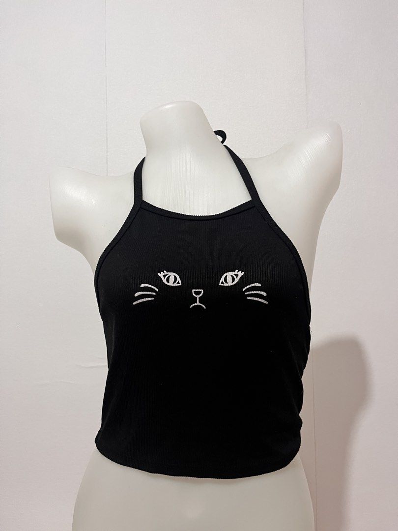 Black Cat Face Halter Crop Top (Category: Sleeveless) located in Manila. Submitted by chimcheese (Listing ID 1461582405, Image 1). Description: - Cute black halter crop top - White cat face design - Ribbed material for a comfortable fit - Ties at the neck and back for adjustable styling - Versatile for casual wear or a night out - Fun and playful style.