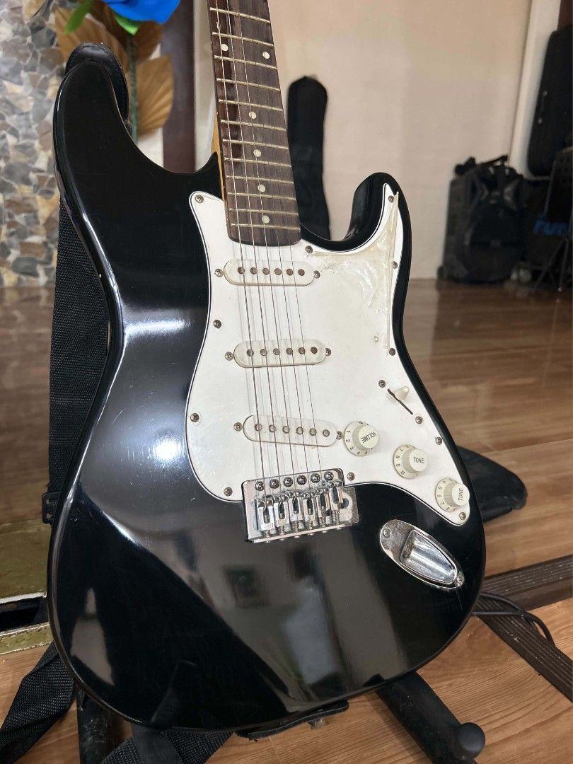 Black Electric Guitar with White Pickguard (Category: Musical Instruments) located in Manila. Submitted by grace_san48 (Listing ID 1461760931, Image 2). Description: - Sleek black electric guitar - Classic white pickguard and pickups - Standard volume and tone controls - Comes with a guitar strap - Perfect for a new musician or collector! *Gifted and barely used. Stored ever since—just needs new strings!.