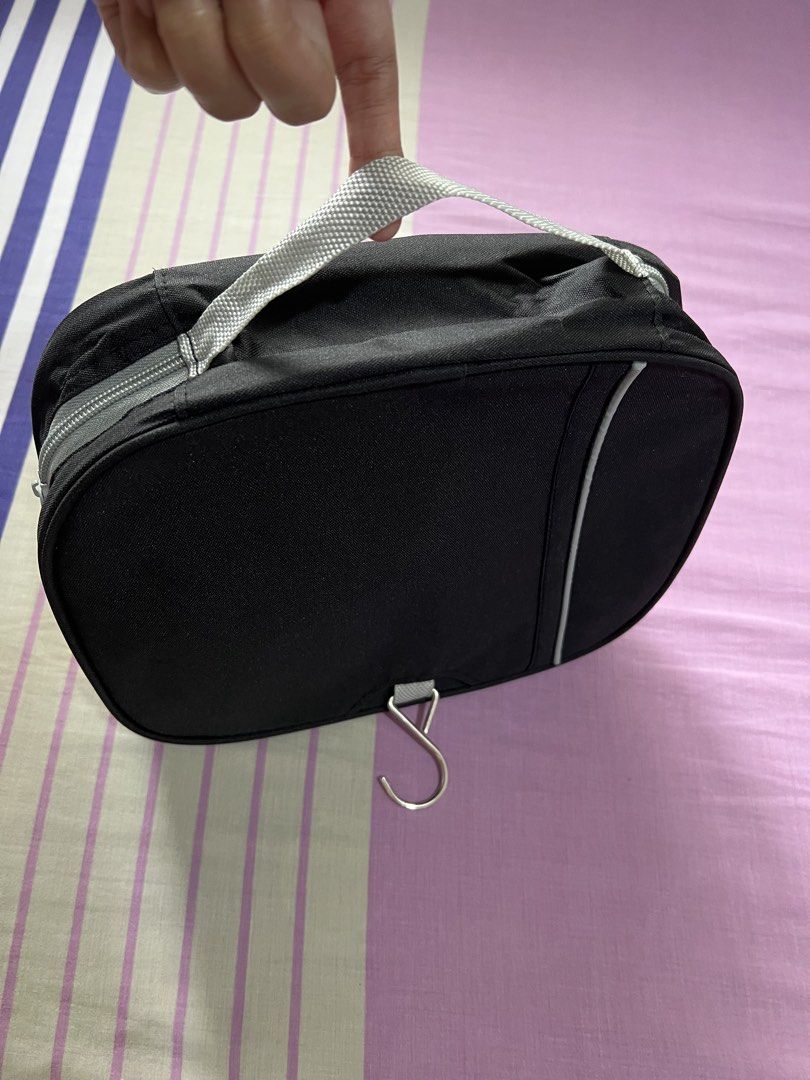 Black Hanging Toiletry Bag with Multiple Compartments (Category: Belt bags, Clutches and Pouches) located in Caloocan City. Submitted by allotherthings26 (Listing ID 1461573985, Image 3). Description: - Black toiletry bag - Built-in hook for easy hanging - Interior mesh pocket for visibility - Elastic loops to secure items - Compact and travel-friendly design - Ideal for toiletries, makeup, and small accessories - Keeps essentials organized and a