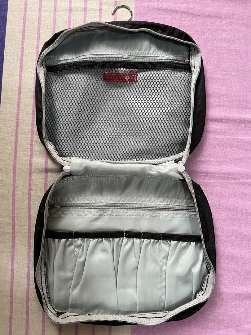 Black Hanging Toiletry Bag with Multiple Compartments (Category: Belt bags, Clutches and Pouches) located in Caloocan City. Submitted by allotherthings26 (Listing ID 1461573985, Image 2). Description: - Black toiletry bag - Built-in hook for easy hanging - Interior mesh pocket for visibility - Elastic loops to secure items - Compact and travel-friendly design - Ideal for toiletries, makeup, and small accessories - Keeps essentials organized and a
