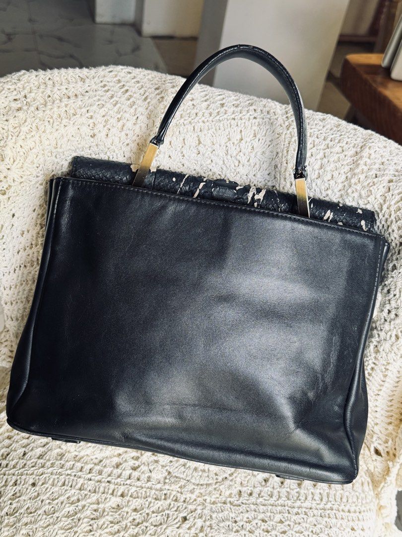 Black Leather Snake Print Handbag (Category: Luxury Bags & Wallets) located in Bacolod City. Submitted by vintage_vogue6100 (Listing ID 1461669961, Image 3). Description: - Genuine black leather handbag - Eye-catching snake print flap with unique paint splatter design - Elegant gold hardware accents - Comes with a detachable shoulder strap for versatile carrying - Spacious main compartment for all your essentials - Interior zippered pocket for se