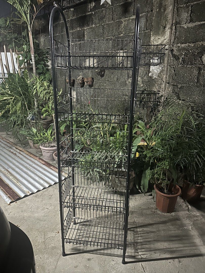 Black Metal Tiered Shelf Rack Stand (Category: Shelves, Cabinets & Racks) located in Cebu City. Submitted by oxywoxy (Listing ID 1461793188, Image 1). Description: - Tall black metal shelf rack - Multiple tiers for storage or display - Perfect for plants or organizing items - Sturdy construction - Ideal for corners or against walls - Ready for a new home.
