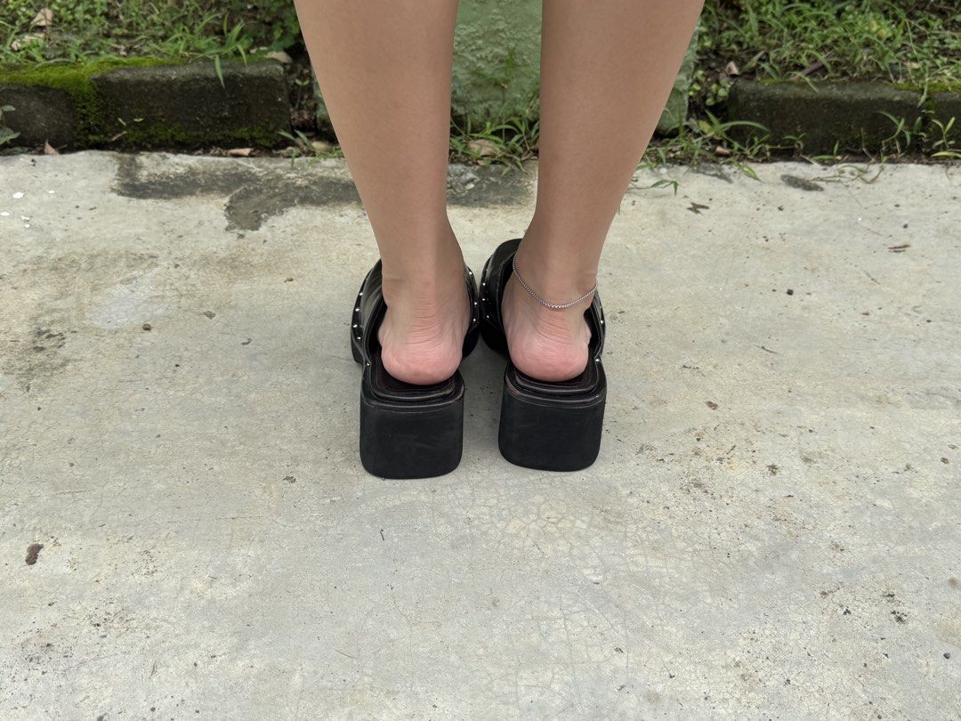 Black Square Toe Platform Clogs with Studs (Category: Flats & Sandals) located in Pasig City. Submitted by raeraesold333 (Listing ID 1461587903, Image 3). Description: SIZE 38 - Stylish black clogs - Trendy square toe - Chunky platform heel - Studded detailing around the sole - Easy slip-on design - Perfect for adding an edgy touch to any outfit - Comfortable for walking.