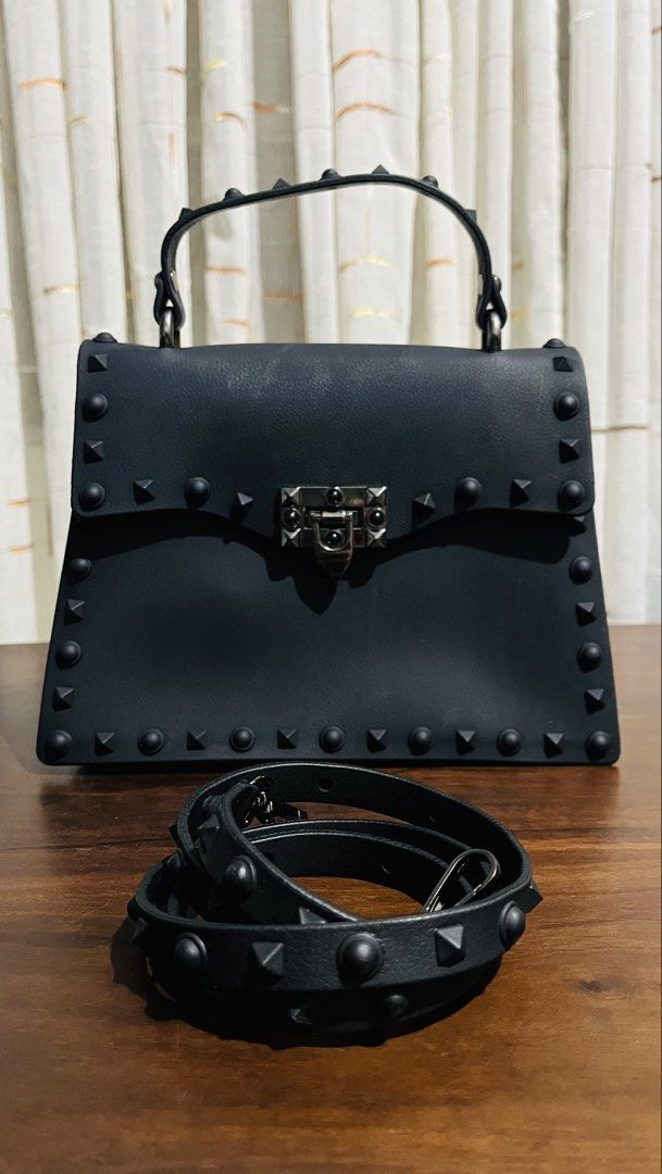 Black Studded Jelly Handbag with Detachable Strap (Category: Luxury Bags & Wallets) located in Iloilo. Submitted by yangfire (Listing ID 1461565299, Image 1). Description: - Cool black handbag with edgy stud detailing all around. - Versatile with both a top handle and a detachable strap. - Surprisingly spacious interior to fit your essentials. - Secure front lock closure for peace of mind. - Ideal accessory for your next night out or special occa