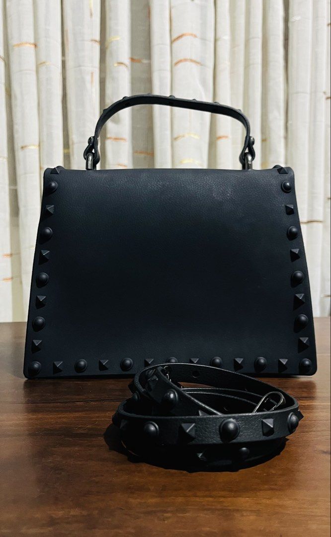 Black Studded Jelly Handbag with Detachable Strap (Category: Luxury Bags & Wallets) located in Iloilo. Submitted by yangfire (Listing ID 1461565299, Image 2). Description: - Cool black handbag with edgy stud detailing all around. - Versatile with both a top handle and a detachable strap. - Surprisingly spacious interior to fit your essentials. - Secure front lock closure for peace of mind. - Ideal accessory for your next night out or special occa