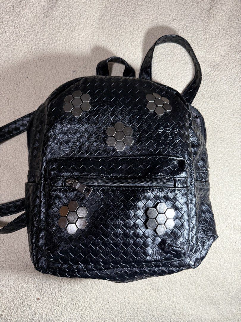 Black Woven Backpack with Hexagonal Studs (Category: Backpacks) located in Manila. Submitted by paulseller009 (Listing ID 1461747309, Image 1). Description: - Stylish black backpack with a unique woven texture. - Decorated with eye-catching shiny hexagonal studs on the front. - Includes a convenient front zip pocket for quick access. - Spacious main compartment for all your essentials. - Adjustable straps ensure a comfortable fit for everyone. - 