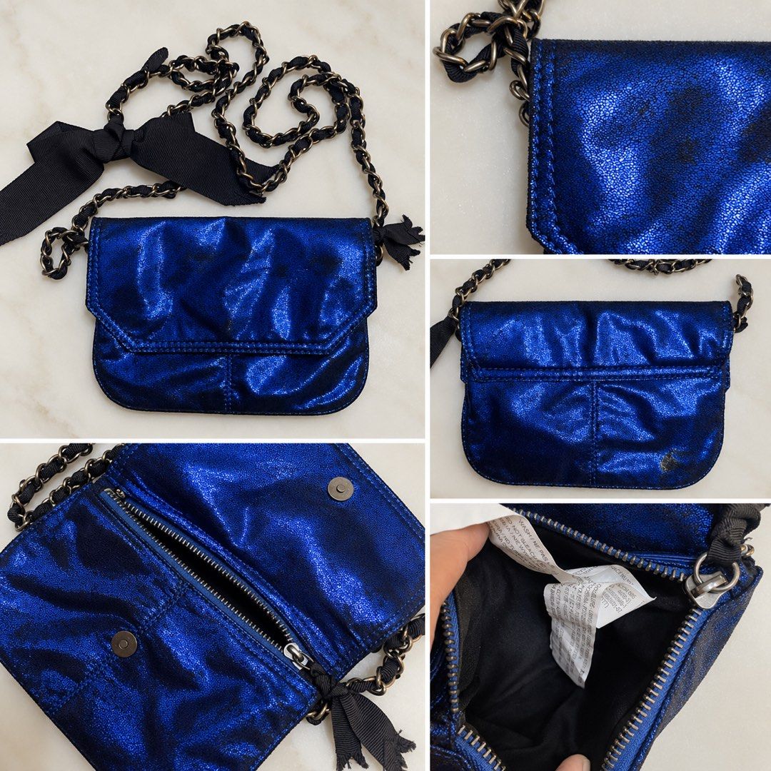 Blue Metallic Chain Strap Crossbody Bag with Bow (Category: Cross-body Bags) located in Makati City. Submitted by stylehub.mnl (Listing ID 1461568288, Image 2). Description: - Adorable blue metallic crossbody bag - Features a chic black ribbon tied to the chain strap - Stylish tassel detail on one end of the chain strap - Secure zipper closure for the main compartment - Includes a small inner pocket for essentials.