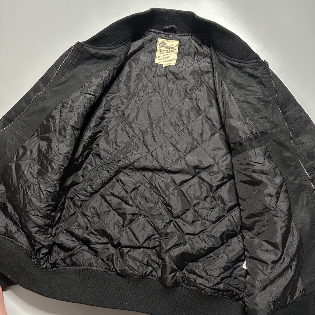 Bomber Jacket (Category: Coats, Jackets and Outerwear) located in Baguio. Submitted by subaitems (Listing ID 1461642982, Image 3). Description: - Black bomber jacket by Natural Story - Quilted lining for extra warmth - Zip-up front closure - Two side pockets - Zippered pocket on the sleeve - Ribbed collar, cuffs, and hem - Ideal for everyday casual wear.