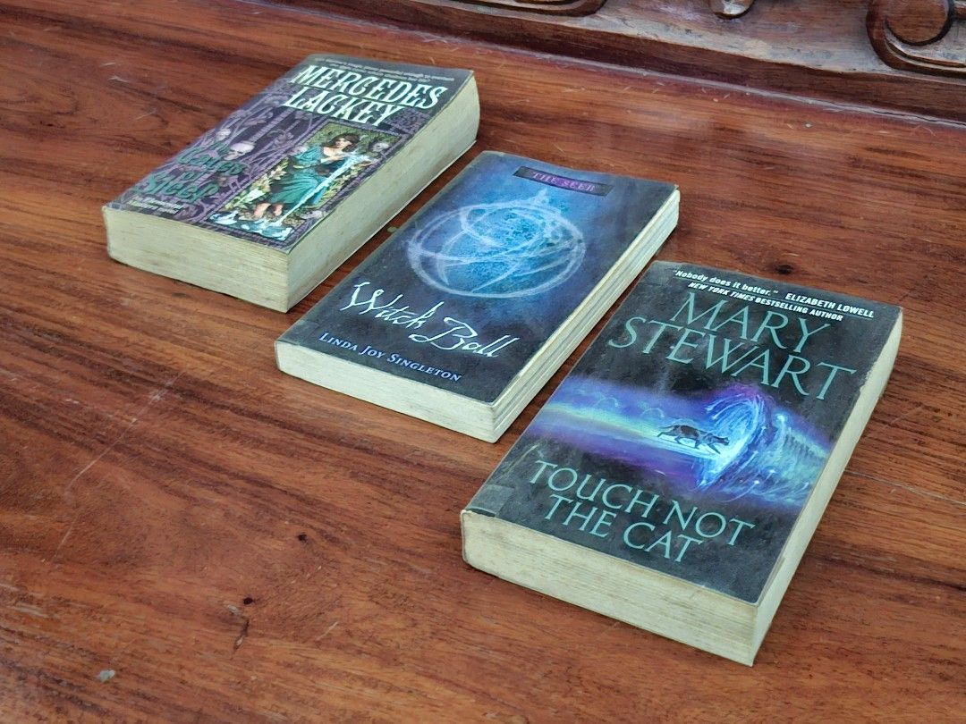 Book Bundle: Fantasy Books (Category: Storybooks) located in Caloocan City. Submitted by bycara (Listing ID 1461583644, Image 2). Description: Selling three fantasy novels. Includes 'The Gates of Sleep' by Mercedes Lackey, 'Witch Ball' by Linda Joy Singleton, and 'Touch Not the Cat' by Mary Stewart. Great reads for fantasy lovers. Grab these for your next adventure. Condition: • Preloved, with signs of wear (yellowed pages, foxing, spine crease, 
