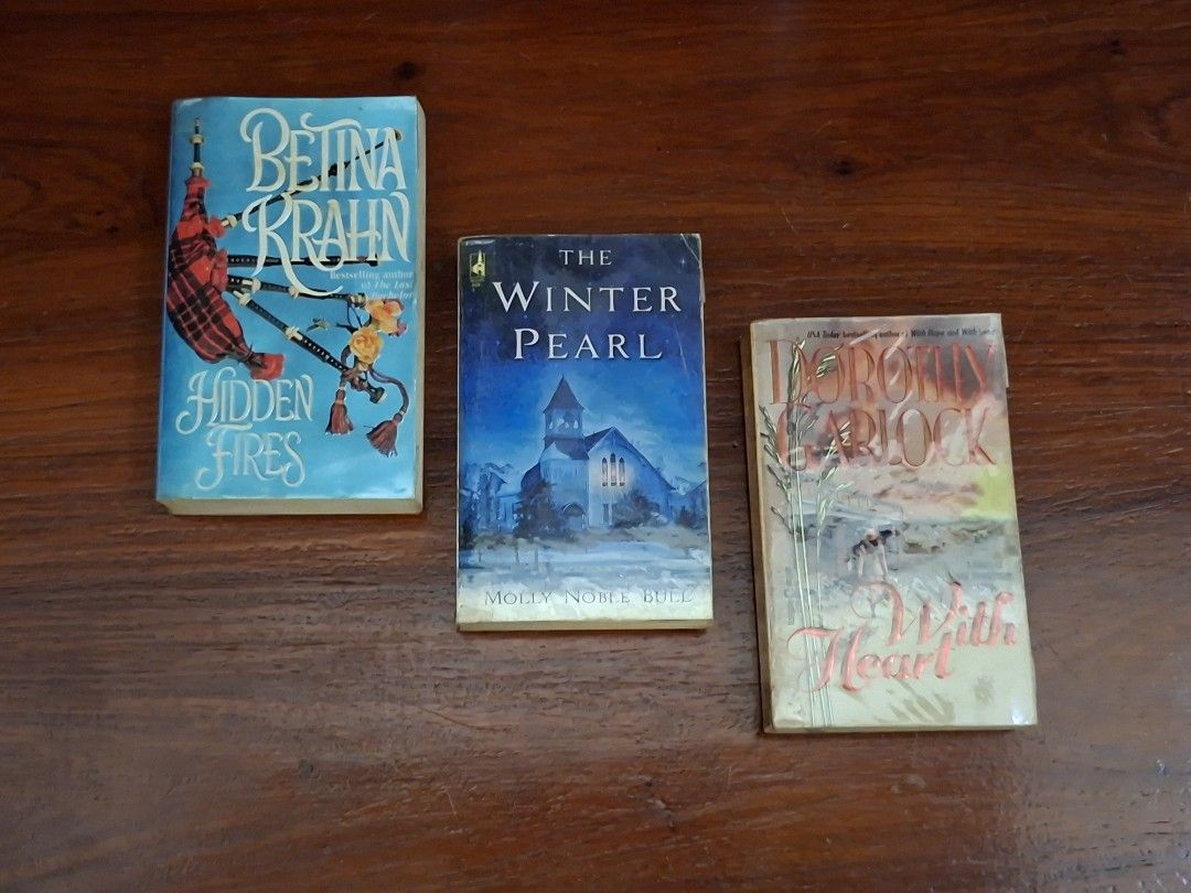 Book Bundle: Romance Adult Books (Category: Storybooks) located in Caloocan City. Submitted by bycara (Listing ID 1461584137, Image 1). Description: Selling three books: 'Hidden Fires' by Bettina Krahn, 'The Winter Pearl' by Molly Noble Bull, and 'With Heart' by Dorothy Garlock. Great reads for your collection. Grab them now! Condition: • Preloved, with signs of wear (yellowed pages, foxing, spine crease, dust marks) • Plastic cover protected 🛵: