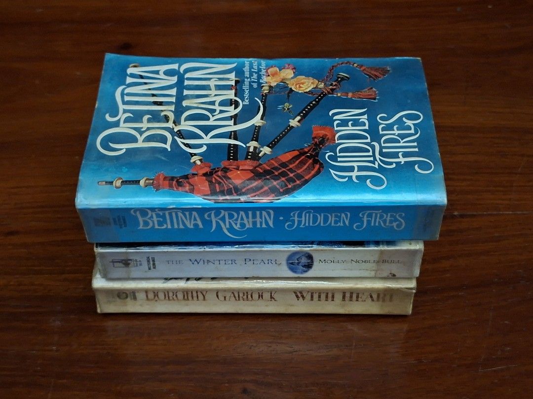 Book Bundle: Romance Adult Books (Category: Storybooks) located in Caloocan City. Submitted by bycara (Listing ID 1461584137, Image 3). Description: Selling three books: 'Hidden Fires' by Bettina Krahn, 'The Winter Pearl' by Molly Noble Bull, and 'With Heart' by Dorothy Garlock. Great reads for your collection. Grab them now! Condition: • Preloved, with signs of wear (yellowed pages, foxing, spine crease, dust marks) • Plastic cover protected 🛵: