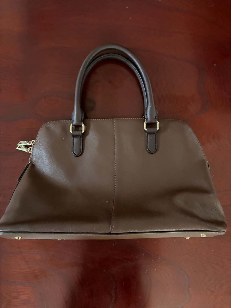 Brown DKNY Satchel (Category: Luxury Bags & Wallets) located in Paete. Submitted by rjpo18 (Listing ID 1461709875, Image 2). Description: Brand: DKNY Style: Structured zip-top satchel/handbag Color: Brown/Mink Material: Saffiano/textured synthetic leather Hardware: Gold-tone.