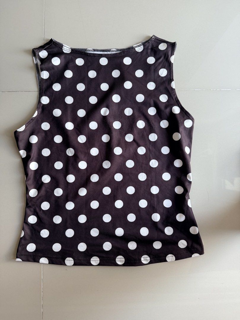 Brown Polka Dot Sleeveless Tank Top Size L (Category: Sleeveless) located in Quezon City. Submitted by welovedclothing (Listing ID 1461573909, Image 1). Description: - Chic brown tank top with classic white polka dots. - Sleeveless design for a cool and breezy feel. - Crafted from a comfortable polyester and elastane blend, offering stretch and ease of movement. - Versatile piece: ideal for casual outings or as a layering essential. - Effortlessl