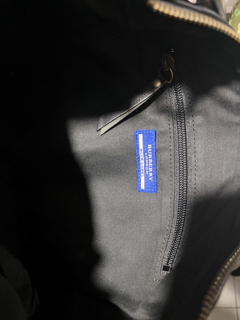 Burberry Blue Label Plaid Leather Shoulder Bag (Category: Luxury Bags & Wallets) located in Tabuk. Submitted by collectors_thrift_shop (Listing ID 1461637994, Image 3). Description: - Authentic Burberry Blue Label shoulder bag - Classic plaid pattern with black leather accents - Secure zipper closure - Interior zipped pocket - Features a blue Burberry Blue Label tag - Ideal for everyday use - Spacious interior.