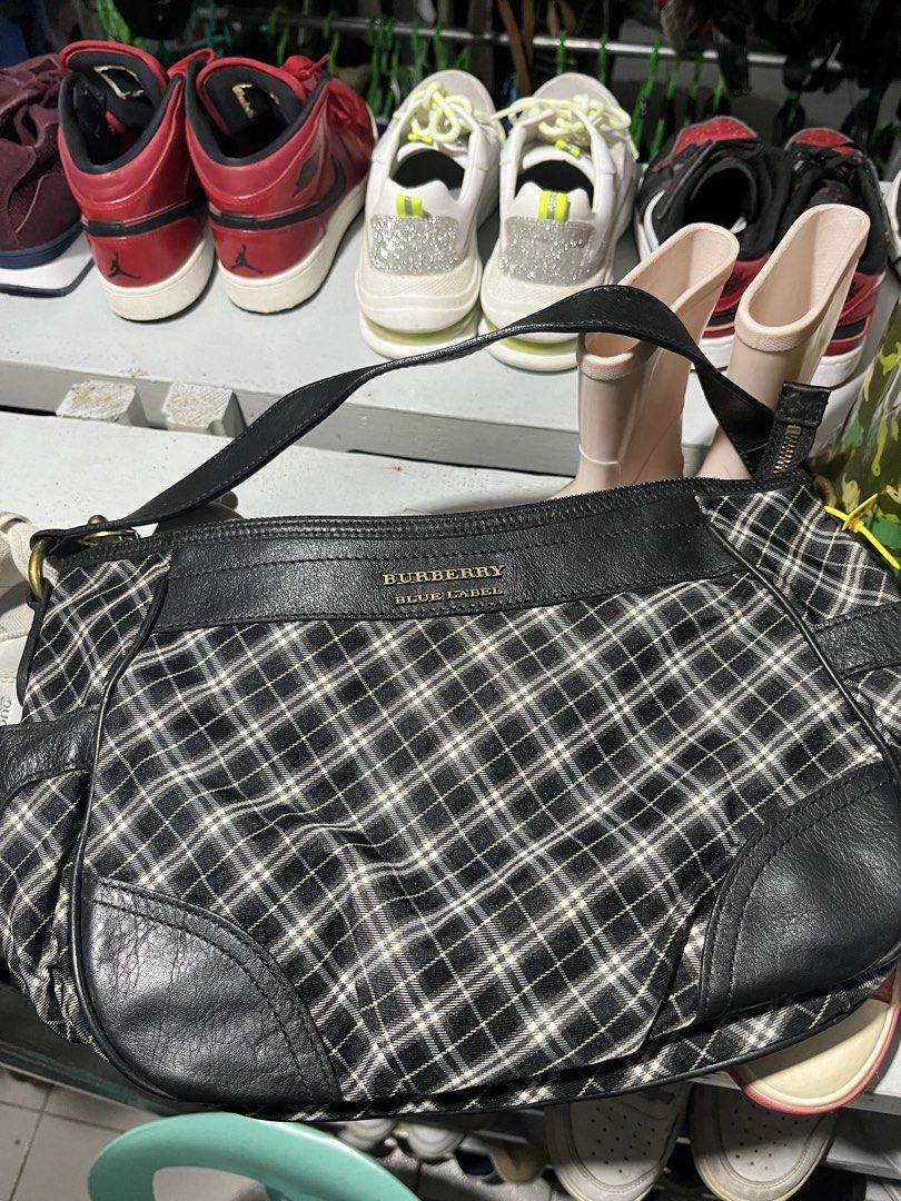 Burberry Blue Label Plaid Leather Shoulder Bag (Category: Luxury Bags & Wallets) located in Tabuk. Submitted by collectors_thrift_shop (Listing ID 1461637994, Image 1). Description: - Authentic Burberry Blue Label shoulder bag - Classic plaid pattern with black leather accents - Secure zipper closure - Interior zipped pocket - Features a blue Burberry Blue Label tag - Ideal for everyday use - Spacious interior.