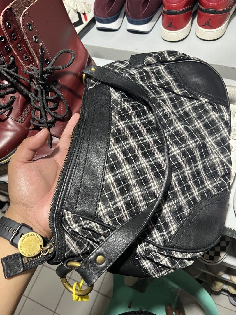 Burberry Blue Label Plaid Leather Shoulder Bag (Category: Luxury Bags & Wallets) located in Tabuk. Submitted by collectors_thrift_shop (Listing ID 1461637994, Image 2). Description: - Authentic Burberry Blue Label shoulder bag - Classic plaid pattern with black leather accents - Secure zipper closure - Interior zipped pocket - Features a blue Burberry Blue Label tag - Ideal for everyday use - Spacious interior.