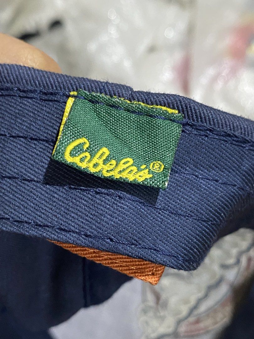 CABELA'S WORLD'S FOREMOST OUTFITTER CAP (Category: Caps & Hats) located in Binmaley. Submitted by vanilla_style (Listing ID 1461741861, Image 3). Description: • Authentic Cabela’s — USA outdoor brand 🇺🇸 • Color: Navy Blue + Rust Orange brim • Adjustable brass buckle strap — fits all head sizes • Embroidered logo — classic vintage style • Clean condition — no holes/stains.