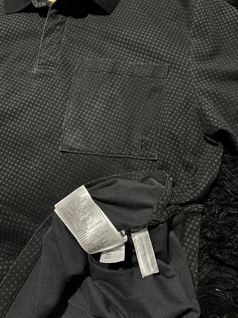 Calvin Klein Men's Black Patterned Polo Shirt (Category: Tshirts & Polo Shirts ) located in Munoz. Submitted by bb_jimbo0 (Listing ID 1461745888, Image 3). Description: - Black Calvin Klein polo shirt - Subtle all-over dot pattern - Chest pocket with small CK logo - Button-up collar - Ideal for casual wear 21 W 28 L.