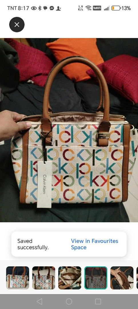 Calvin Klein Monogrammed Satchel Handbag (Category: Shoulder Bags) located in Manila. Submitted by wildwind_73f77a (Listing ID 1461640026, Image 3). Description: - Cute Calvin Klein satchel bag - All-over CK monogram print - Brown leather trim and handles - Zipper closure - Front pockets - Original tag still attached - Measures approximately 13 inches wide.