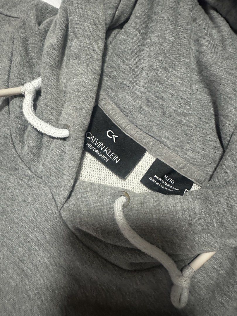 Calvin Klein Performance Grey Hoodie (Category: Hoodies) located in Baybay. Submitted by comicowl (Listing ID 1461720736, Image 2). Description: - Grey Calvin Klein Performance hoodie - Features iconic Calvin Klein logo on the front - Size XL/TG - Made in Indonesia - Comfortable and casual design - Perfect for everyday wear.