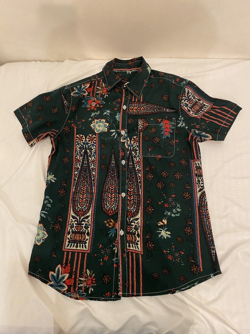 Casual Patterned Dark Green Button-up (Category: Tshirts & Polo Shirts ) located in Quezon City. Submitted by pixavix (Listing ID 1461701202, Image 1). Description: - Green short sleeve button-up shirt - All-over floral and paisley print - Left chest pocket - Front button closure - Ideal for casual wear or a night out - Unique design.
