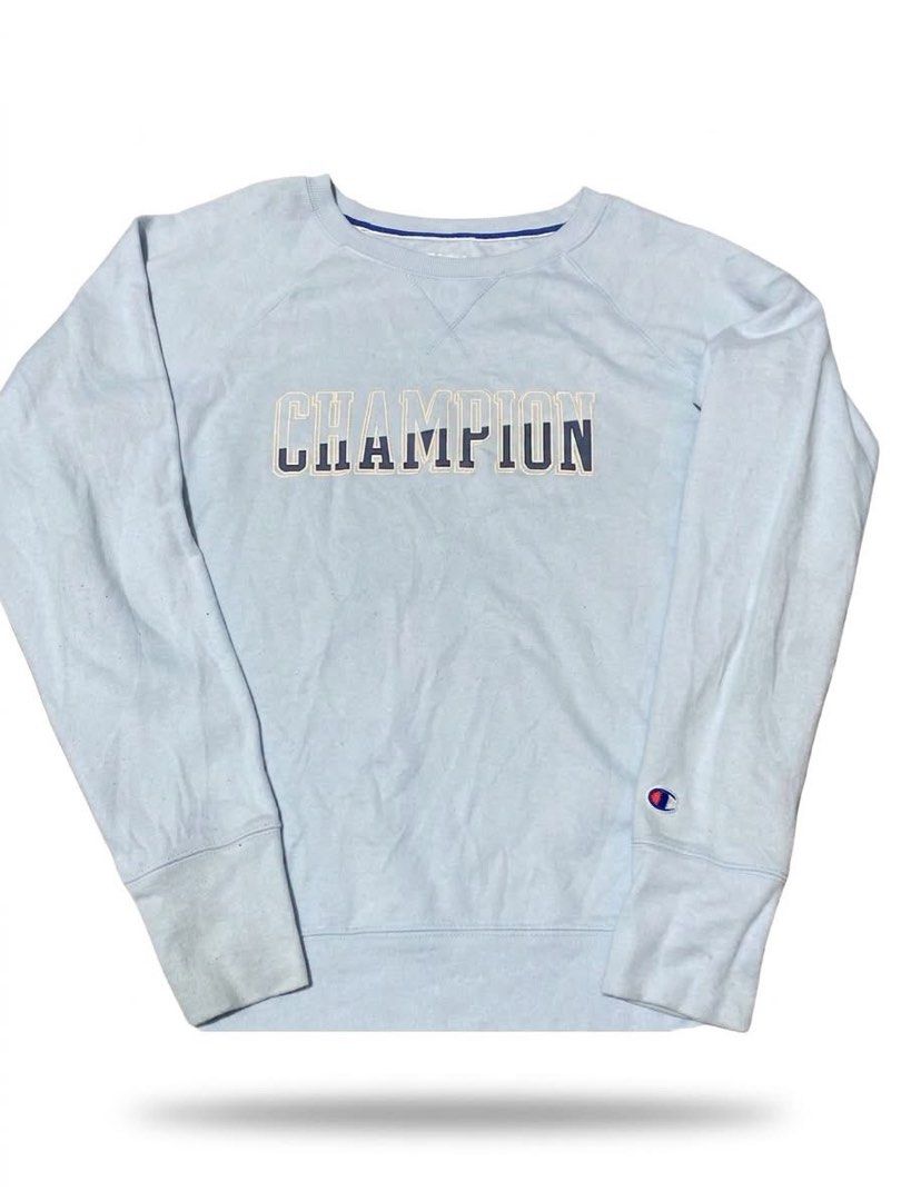 Champion Light Blue Graphic Sweatshirt (Category: Coats, Jackets and Outerwear) located in Pasay City. Submitted by ken_98 (Listing ID 1461595614, Image 1). Description: - Light blue Champion sweatshirt - Features Champion logo across the chest - Classic crewneck with long sleeves - Champion logo patch on the left sleeve - Ideal for casual wear.