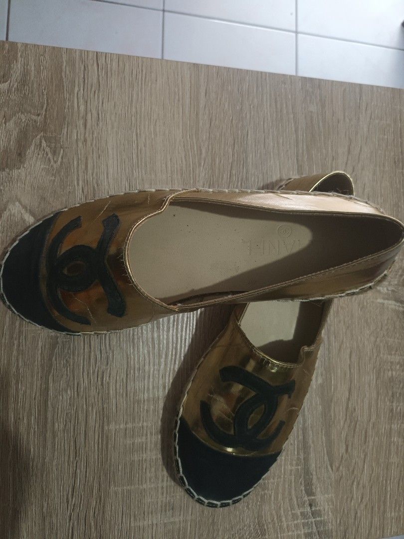 Chanel Gold Espadrilles with Black Cap Toe (Category: Sneakers & Footwear) located in Cainta. Submitted by ma_tres (Listing ID 1461593804, Image 1). Description: - Authentic Chanel Gold Espadrilles - Size: 37 - Iconic CC logo on the toe cap - Black toe cap with elegant white stitching detail - Classic espadrille sole - Ideal for chic, casual wear.
