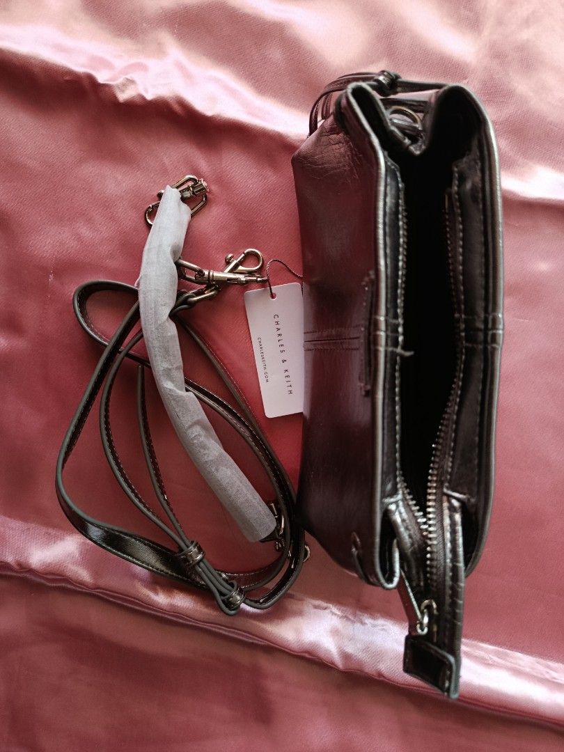 Charles & Keith Metallic Crossbody Bag (Category: Cross-body Bags) located in Pasig City. Submitted by pinkymon1029 (Listing ID 1461739839, Image 2). Description: - Charles & Keith metallic crossbody bag - Long, adjustable strap - Zip-top main compartment - Small inner pocket - Comes with original tag - Ideal for carrying your essentials.