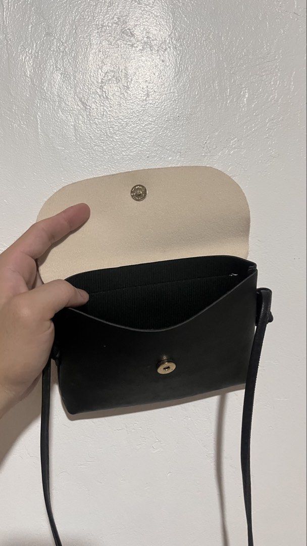 Chic Two-Tone Crossbody Sling Bag (Category: Cross-body Bags) located in Dinalupihan. Submitted by banditvaultco (Listing ID 1461749336, Image 2). Description: Stylish & Minimalist Everyday Crossbody Bag - chic, compact sling bag that matches easily with any casual outfit Design: Two-tone colorway (Cream top flap with a solid Black body) Features: Secure magnetic snap button closure, long slim shoulder strap, and an open main compartment perfect 