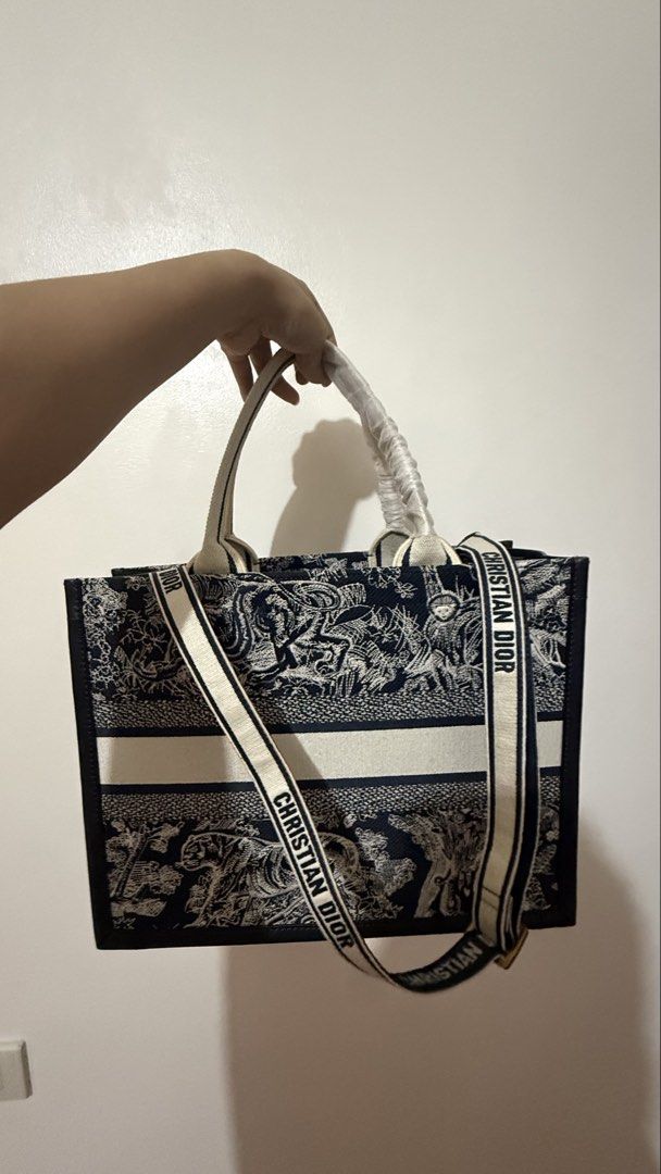 Christian Dior Booktote (Category: Tote Bags) located in Manila. Submitted by prelovedrepubliq (Listing ID 1461752281, Image 2). Description: Comes with dustbag and sling Canvas and genuine leather on the side.