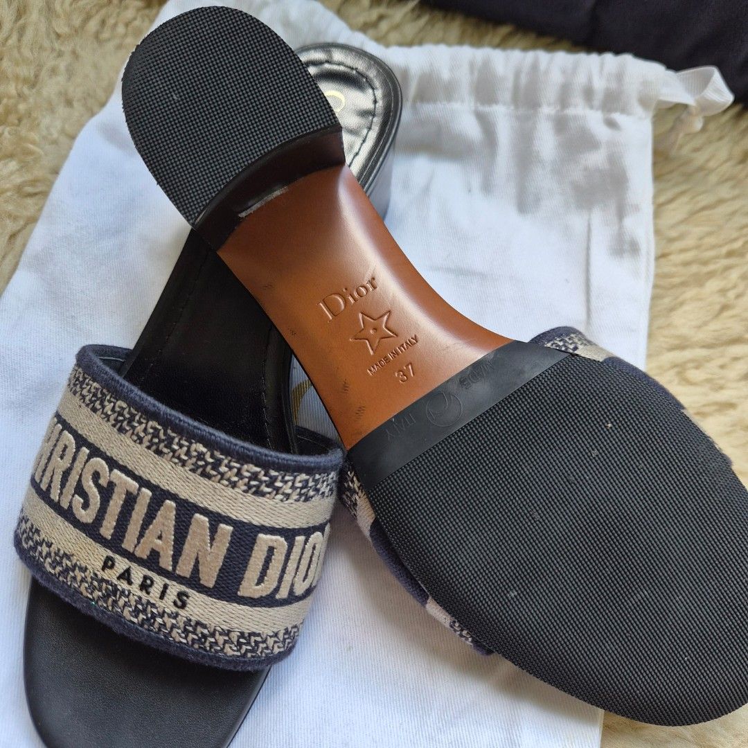 Christian Dior Dway Slide Sandals (Category: Flats & Sandals) located in Quezon City. Submitted by deng43763 (Listing ID 1461569337, Image 2). Description: - Authentic Dior Dway slide sandals - Color: Beige and Navy canvas - Design: Christian Dior Paris embroidery - Heel type: Block heel - Size: 37 - Origin: Made in Italy - Includes: Original dust bag.