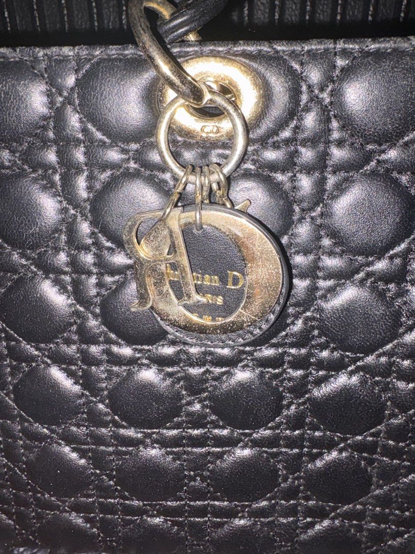 Christian Dior Large Lady Dior (Category: Purses & Pouches) located in Batangas. Submitted by strtdcltrs (Listing ID 1461728657, Image 2). Description: Christian Dior Large Lady Dior in Black NGA OFF FROM CANAL STREET Lambskin leather with Cannage quilting Hardware: Gold-tone Interior: Vibrant red lining featuring the signature Dior monogram pattern, equipped with an interior zippered pocket. .