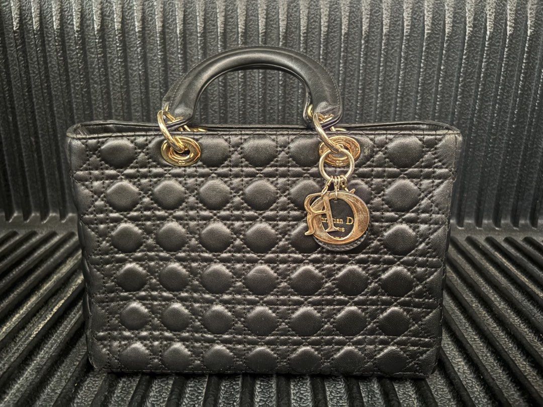 Christian Dior Large Lady Dior (Category: Purses & Pouches) located in Batangas. Submitted by strtdcltrs (Listing ID 1461728657, Image 1). Description: Christian Dior Large Lady Dior in Black NGA OFF FROM CANAL STREET Lambskin leather with Cannage quilting Hardware: Gold-tone Interior: Vibrant red lining featuring the signature Dior monogram pattern, equipped with an interior zippered pocket. .
