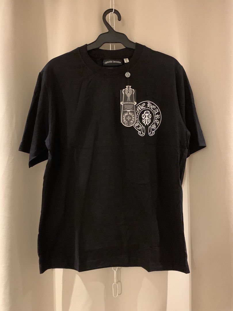 Chrome Hearts Black Dagger & Scroll T-Shirt (Category: Tshirts & Polo Shirts ) located in Manila. Submitted by vintaurafindsco. (Listing ID 1461705585, Image 1). Description: - Authentic Chrome Hearts T-Shirt - Iconic dagger and scroll design on the back - Small Chrome Hearts logo on the front chest - Made from comfortable material - Classic fit - A must-have for any Chrome Hearts fan!.