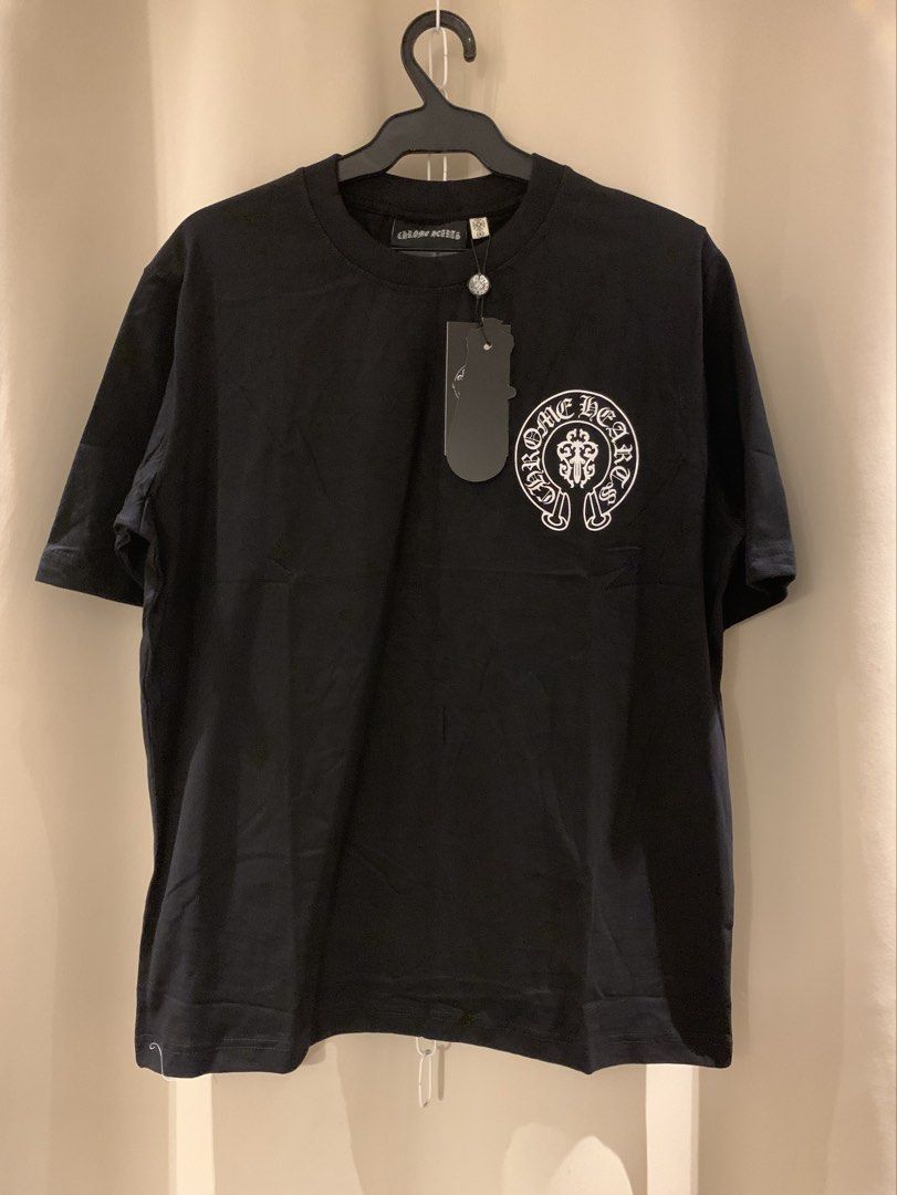Chrome Hearts Black T-Shirt (Category: Tshirts & Polo Shirts ) located in Manila. Submitted by vintaurafindsco. (Listing ID 1461705346, Image 2). Description: - Authentic Black Chrome Hearts T-Shirt - Features iconic dagger and scroll design on the back - Small Chrome Hearts logo on the front chest - Comes with original tags attached - Perfect addition to any Chrome Hearts collection.