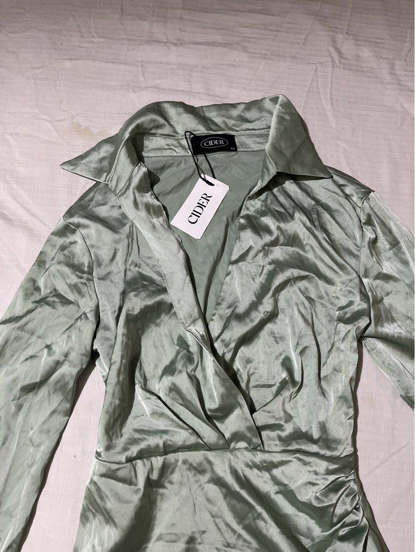 CIDER Green Satin Collared Wrap Mini Dress (Category: Dresses) located in Quezon City. Submitted by earthtodior (Listing ID 1461795518, Image 3). Description: - XS on tag but can fit up to small - Long sleeves with button cuffs - Ruched detail on the side - Collared neckline - Perfect for a night out or special occasion - Still has original tags attached.