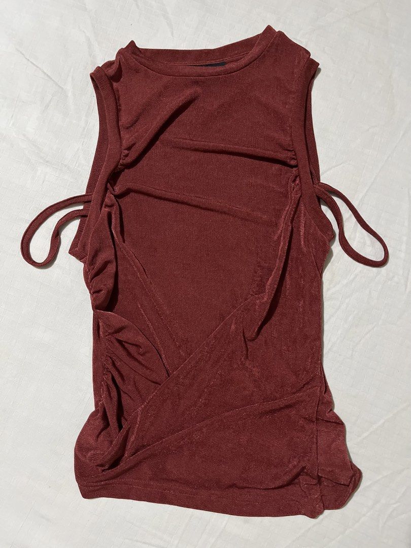 Cider Red Ruched Tie Side Sleeveless Top (Category: Sleeveless) located in Quezon City. Submitted by earthtodior (Listing ID 1461795574, Image 1). Description: - Cute Cider top - Reddish-brown color - Ruched design with side tie details - Sleeveless style - Subtle shimmer fabric - Size S.