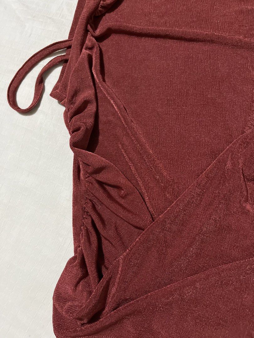 Cider Red Ruched Tie Side Sleeveless Top (Category: Sleeveless) located in Quezon City. Submitted by earthtodior (Listing ID 1461795574, Image 2). Description: - Cute Cider top - Reddish-brown color - Ruched design with side tie details - Sleeveless style - Subtle shimmer fabric - Size S.