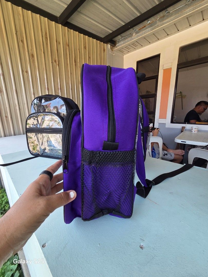 Clear Transparent Backpack with Purple Accents (Category: Backpacks) located in Davao. Submitted by gretchenal19856 (Listing ID 1461580302, Image 2). Description: - Clear transparent backpack - Purple fabric accents on edges and straps - Main zippered compartment - Smaller front zippered pocket - Side mesh pockets - Ideal for school or travel.